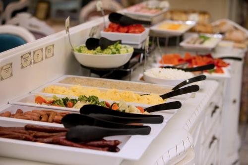 a buffet line with many different types of food at Atostogų Parkas Hotel in Palanga
