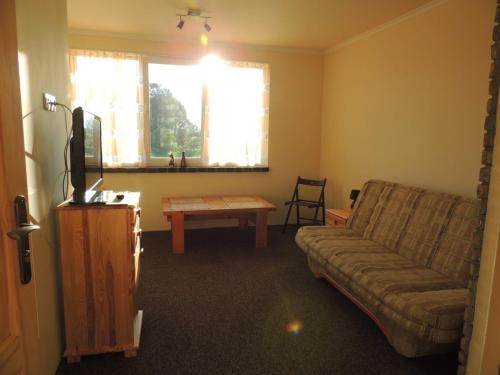 a living room with a couch and a table at BoomerangHouse in Wrocław