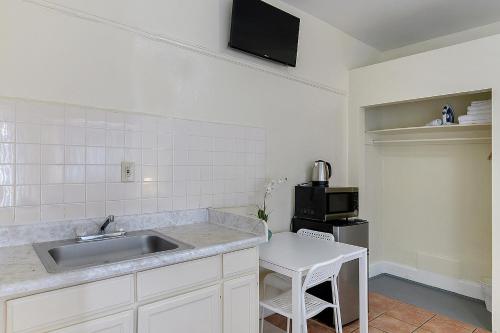 a kitchen with a sink and a microwave at Pads on Pasadena Ave in Los Angeles