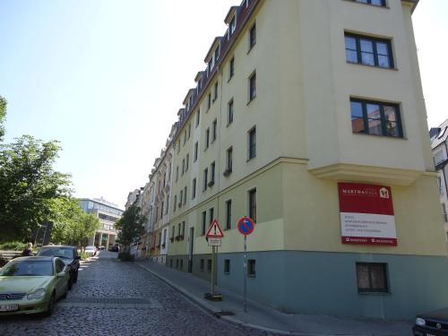 a building on a street with cars parked next to it at Hotel Marthahaus in Halle an der Saale