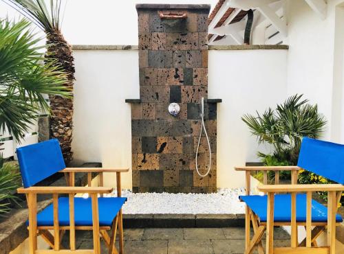 two blue chairs sitting in front of a shower at Casa Lucia in Sorrento