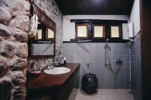 a bathroom with a sink and a mirror at Villa Darakorn Hill Country House in Chiang Rai