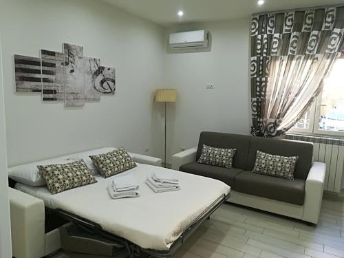 a living room with a bed and a couch at La casa di Donatella in Naples