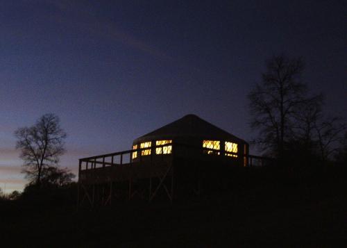 a house lit up at night with lights in it at StoneWind Retreat in Chester