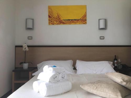 a bedroom with a bed with towels on it at Hotel Royal in San Benedetto del Tronto