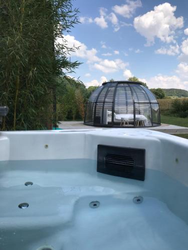 a bird cage sitting on the back of a boat at Les nuits insolites de la mothe - hébergement en bulle ou tiny house avec spa privatif in Outremécourt