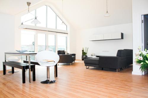 a living room with a table and a couch at Lux Apartment in Bangor