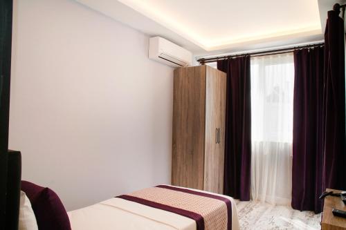 Ένα ή περισσότερα κρεβάτια σε δωμάτιο στο AF-RA Hotel