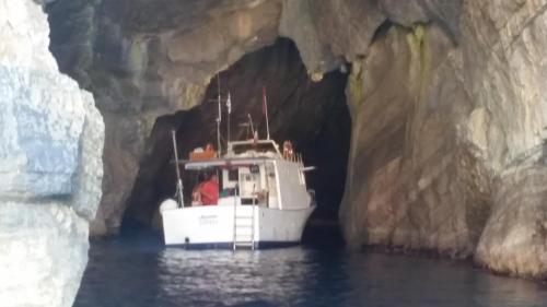 a boat in a cave in the water at Scalovecchio in Marettimo