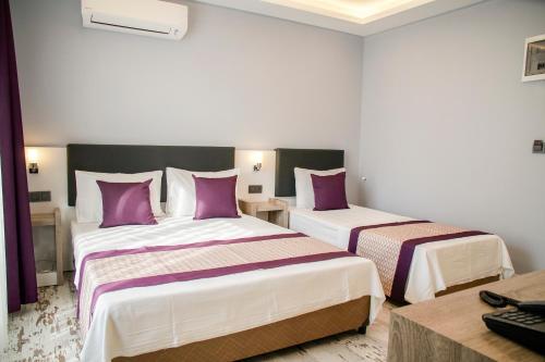 Ένα ή περισσότερα κρεβάτια σε δωμάτιο στο AF-RA Hotel