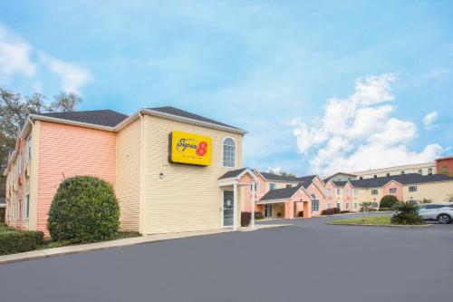 a fast food restaurant with a sign on the side of a building at Super 8 by Wyndham Pensacola in Pensacola