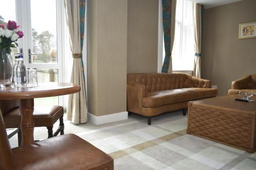 a living room with a couch and a table at The Glenburn Hotel in Rothesay