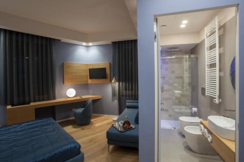 a bathroom with a blue bed and a sink at MaisonSilvi' in Matera