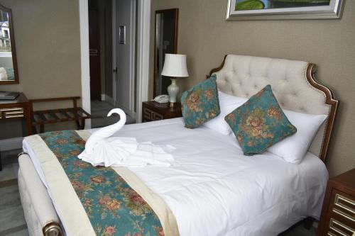 a bedroom with a bed with a swan on it at The Glenburn Hotel in Rothesay