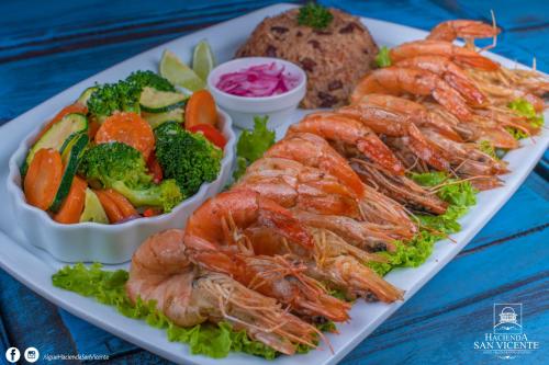 a plate of shrimp and vegetables on a table at Hacienda San Vicente in Flores