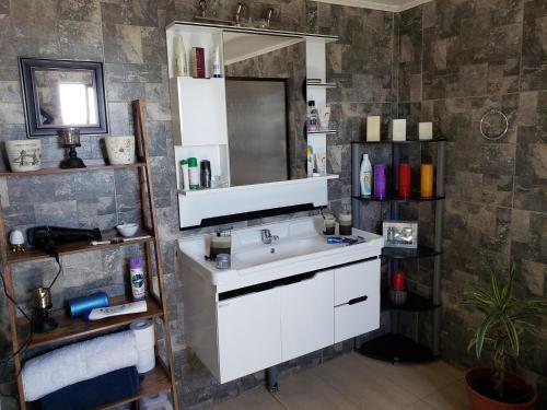 a bathroom with a white sink and a mirror at SALITRE SPA in Pozo Almonte