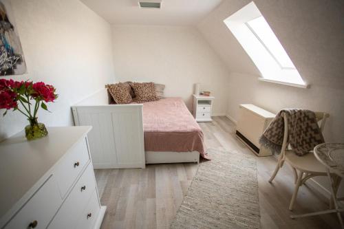 a bedroom with a bed and a desk and a window at Suviste Guesthouse in Kuressaare