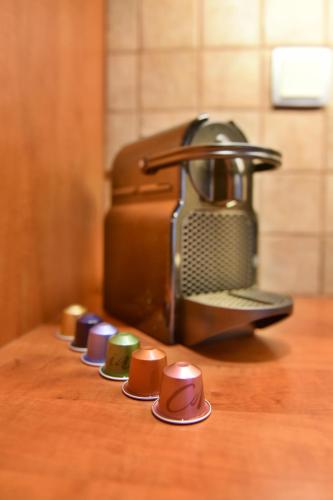 a row of different colored cups on a table at Unique luxury suites in Hydra
