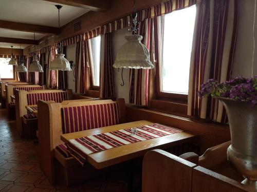 a dining room with a wooden table and chairs at Hotel Restaurant Klostermühle in Reutlingen