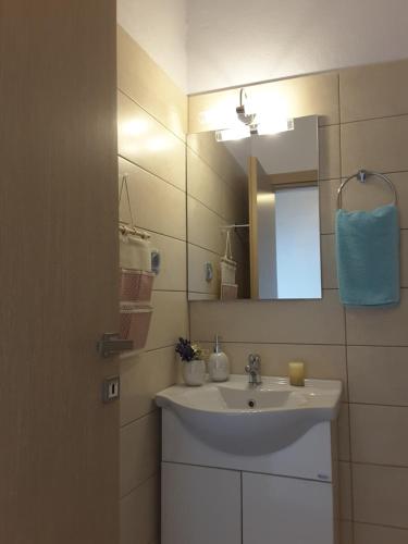 a bathroom with a sink and a mirror at Panorama Apartment in Kefálion