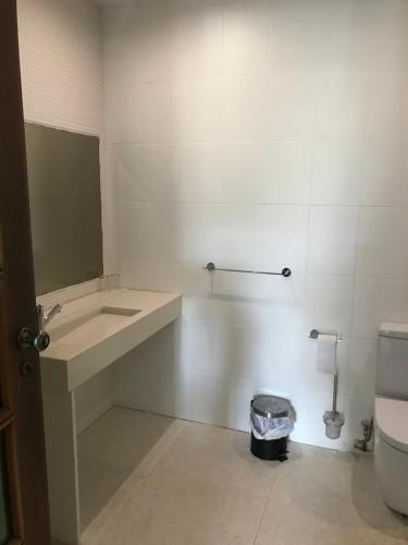 a bathroom with a sink and a toilet at Quartos do Seixe - Azul in Odeceixe