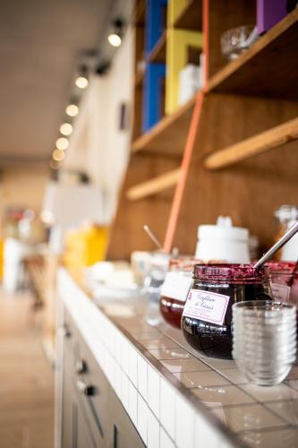 a kitchen counter with bowls and plates on it at greet Hotel Beaune in Beaune