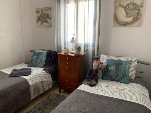 a bedroom with two beds and a dresser at Harmonia Blue Mediterranean Modern Luxury HEATED POOL Prime Location in Polis Chrysochous