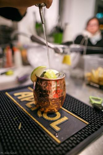 a person is stirring a drink in a cup at The One Hotel - Designed for Adults - Pet lovers in Riccione