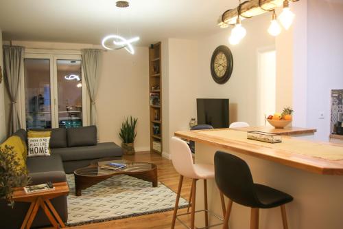 a kitchen and living room with a table and chairs at City Centre Apartment 2 in Shkodër