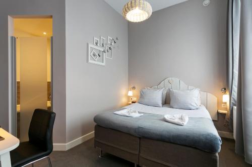 Postel nebo postele na pokoji v ubytování Hotel Heere