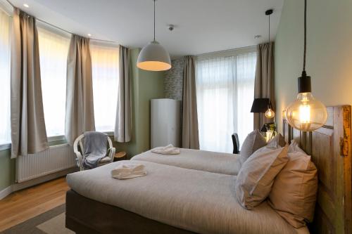 Postel nebo postele na pokoji v ubytování Hotel Heere
