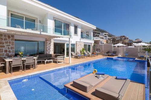 a villa with a swimming pool and a house at Villa La Mer Azur in Kalkan