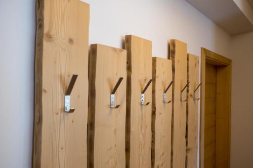 a row of wooden doors in a room at Agritur Piccolo Fiore B&B in Taio