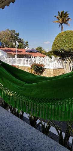 a white fence with a green covering in a park at La Toscana in Chinauta