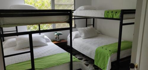two bunk beds in a room with a window at La Toscana in Chinauta