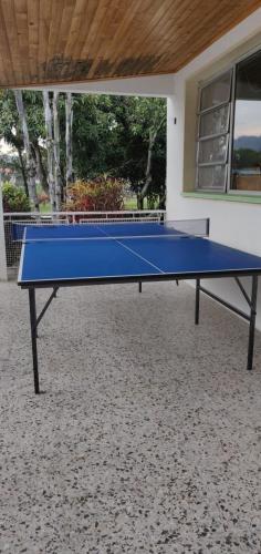 a blue ping pong table in front of a house at La Toscana in Chinauta