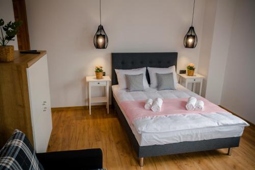 a bedroom with a bed with two night stands at GOLDEN ROOMS blisko Energylandii in Zator