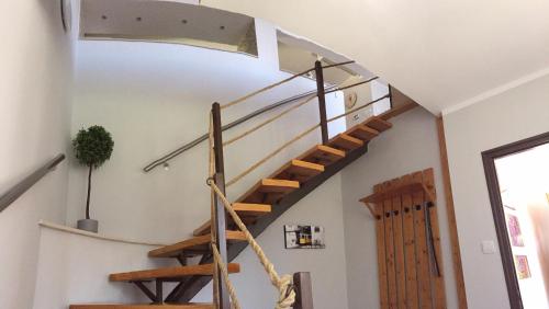 a spiral staircase in a room with a door at Strigonia Apartman in Esztergom