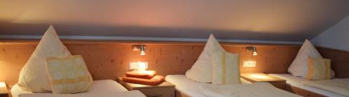 two beds in a room with white sheets and pillows at Hotel zum Goldenen Wagen in Maulburg