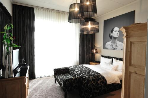 a bedroom with a bed and a large window at Stage47 in Düsseldorf