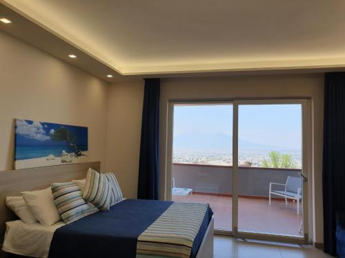 a bedroom with a bed and a view of the ocean at Villa Eden in Corbara