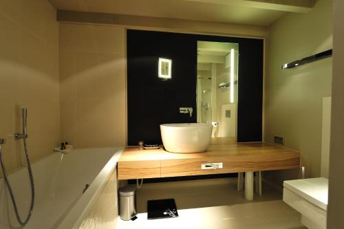 a bathroom with a sink and a shower and a tub at Stage47 in Düsseldorf