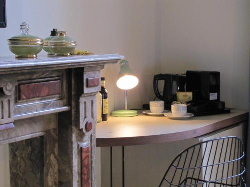 a room with a table with a lamp on it at B&B La Corderie in Hamme