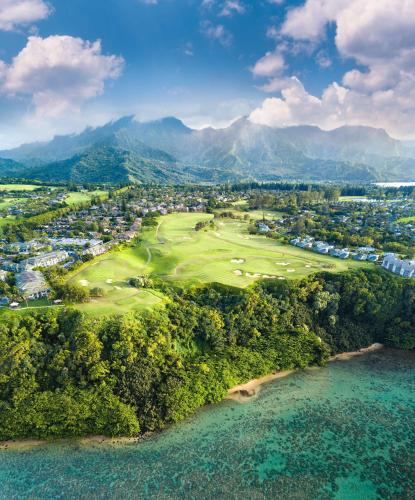 an aerial view of a golf course next to the ocean at The Cliffs at Princeville in Princeville
