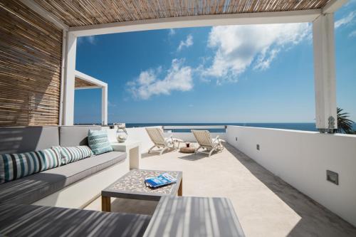 a living room with a view of the ocean at Skyros Ammos Hotel in Skiros