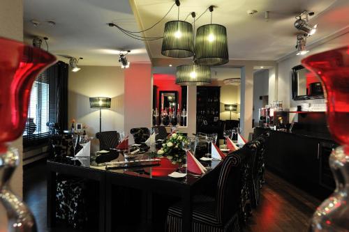 a restaurant with a table with chairs and a bar at Stage47 in Düsseldorf