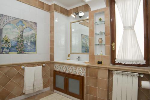 a bathroom with a sink and a mirror at Panorama Host - Domus Amalfi Coast in Maiori