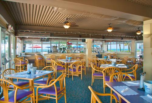 a dining room with tables and chairs in a restaurant at Oceanfront Litchfield Inn in Pawleys Island