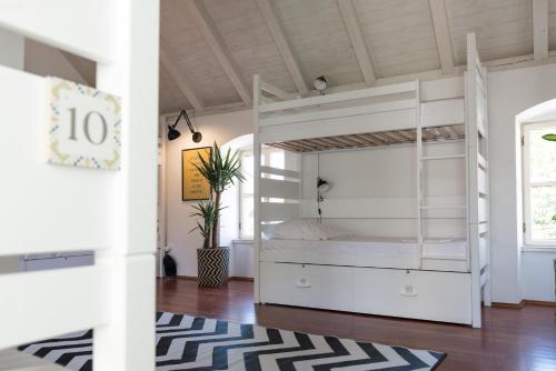 a bedroom with a white bunk bed and a rug at Ćiri Biri Bela Private dorm in Split