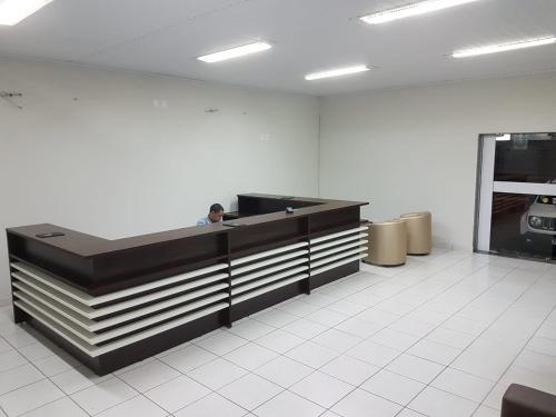 an empty office with a reception desk in a room at Hotel Águia in Teixeira de Freitas